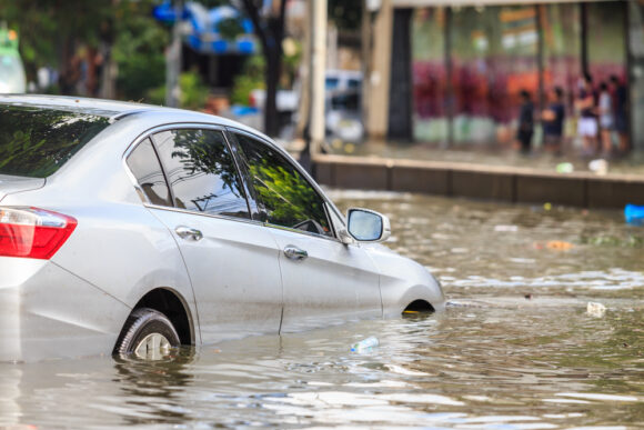 a flood-damaged vehicle stands in water for a few hours