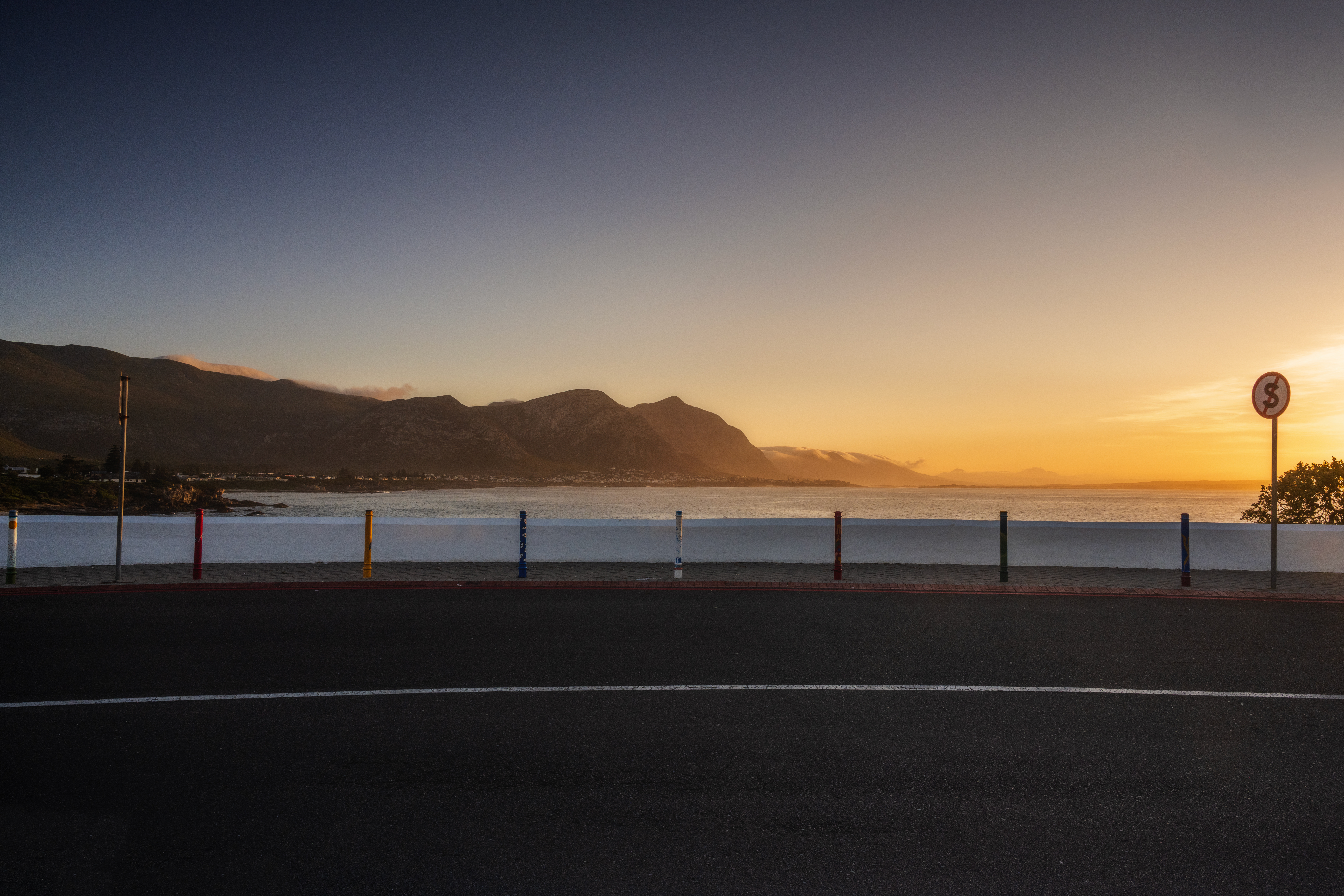 Sunset over the Whale Coast in Hermanus, showcasing the freedom of the open road after finding a driving school near me.